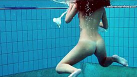 Teen brunette's hot tits and shaved pussy underwater.