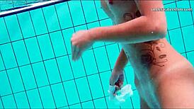 Teen brunette's hot tits and shaved pussy underwater.