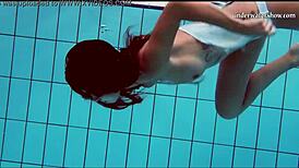 Teen brunette's hot tits and shaved pussy underwater.