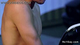 Bodybuilder engages in thrilling gay anal sex in a convertible under the night sky, sucking and fucking with a monster cock.