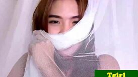 I watch the young 18+ oriental shemale masturbate in close-up.