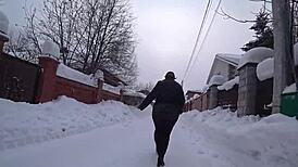 Yo, check this curvy milf's big ass in pantyhose on a snowy street!