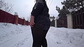 Yo, check this curvy milf's big ass in pantyhose on a snowy street!