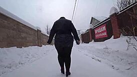Yo, check this curvy milf's big ass in pantyhose on a snowy street!