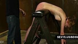 Young redhead gets tied up and choked in garage bondage spanking session