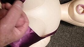Dolly gives handjob in bra, ending with cumshot.