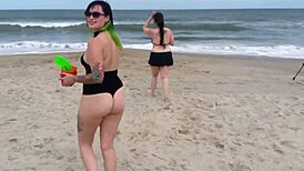 Beautiful women in bikinis at the beach in a photo shoot.