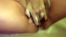 In the bath, the milf relaxes with some soothing masturbation under the water.