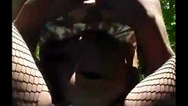 Watch this masked girl masturbating outdoors, she's so horny