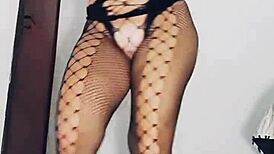 Mireladelicia strips in black fishnets, uses dildo and anal plug