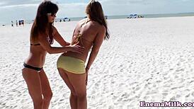 Watch these babes rimming on the beach!