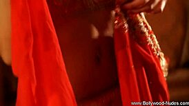 A brunette milf performs a seductive striptease, ripping clothes and undressing slowly