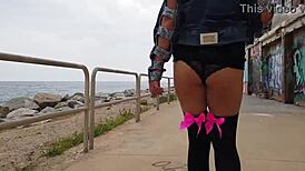 public squirt session unfolds on a sunny beach