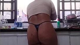 She washes the sink in just her panties at her father-in-law's house, flashing her big ass.