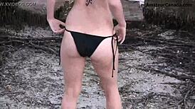 Teen blonde in bikini does a flashing striptease by the beach. Public fun unfolds!