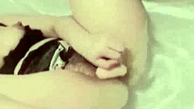 Asian girl masturbates in bathroom watching porn with dildo