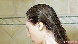 Beautiful girl gets a shower in an adult photo shoot