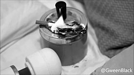 smoking on a dollar bill in a greed fetish scene