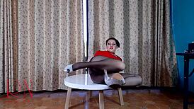 sexy lady strips in pantyhose and heels on round table