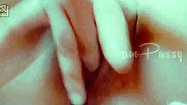 She fingers her shaved pussy closeup