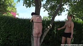 breaking the whips - miss flora and lady deluxe flogging the guy on the fresh air