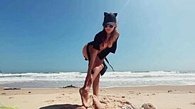 Teen brunette masturbates publicly on nude beach, caressing feet while guy jerks off and cums