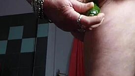 granny shocks by banging hairy pussy with cucumber in kitchen.