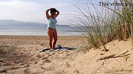 Filming a curvy European babe doing exercises and changing on the public beach