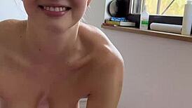 Girl masturbates with vibrator by window