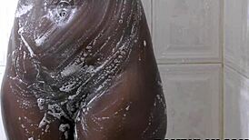 I'm stunned by this ebony beauty's natural boobs in the shower