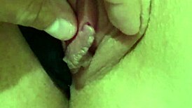 Teasing the redhead's pink pussy with gentle caresses.