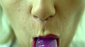 Teen sucking dildo in close-up solo session