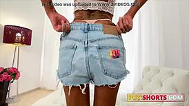 A tattooed beauty in denim shorts gets a big cock in her ass