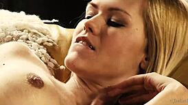 delphine fingers her shaved pussy solo on the sofa