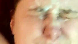 An amateur girl casually gets her face covered in cum