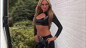 Blonde latex babe Amanda struts outdoor in tight rubber boots