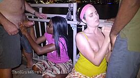 two brunettes giving double handjob on public beach fun