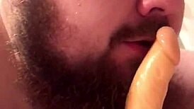 The young gay chub eagerly sucks the dildo before riding it passionately.