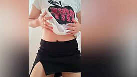 Sexy student with perfect body and big tits films herself in black skirt on camera