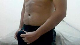 The handsome gay guy moans loudly while jerking off and cumming on his chest