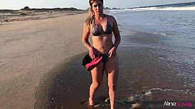 Blonde girl gets wild on the beach banging her fan