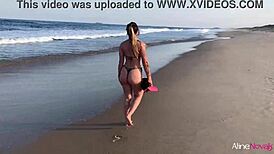 Blonde girl gets wild on the beach banging her fan