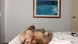Solo ladyboy toys her big cock while smoking in bed