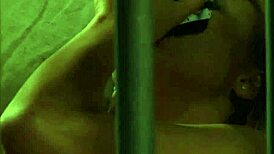 Voyeur watches lesbian slave in bondage. She fingers her big ass and tits, orgasming hard.