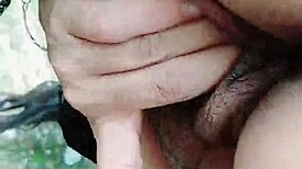 Brunette babe with big natural tits shows off outdoors. Her sensual charm is undeniable!