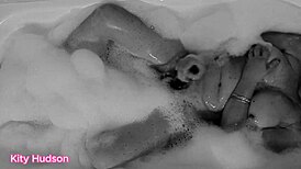 Kitty Hudson enjoys a relaxing bath with a toy