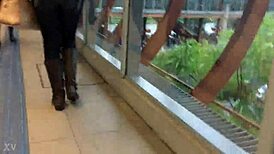 Jacket and boots candidly exposed on the train street scene.