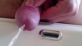 She pisses in the sink, close-up view