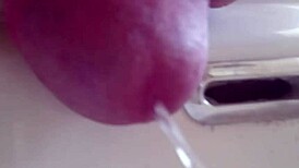 She pisses in the sink, close-up view