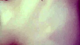 Amateur video with a young woman in an intimate setting.